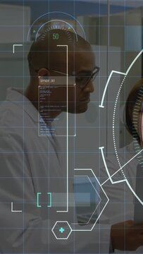 Vertical video: Male scientist scanning device in lab as HUD animating numeric values for analysis