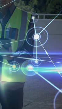 Vertical video: Construction worker using tablet and activating AR HUD nodes for site monitoring