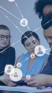 Vertical video: Biz team moving docs to tab as man pulling tab network icons overlaying for review
