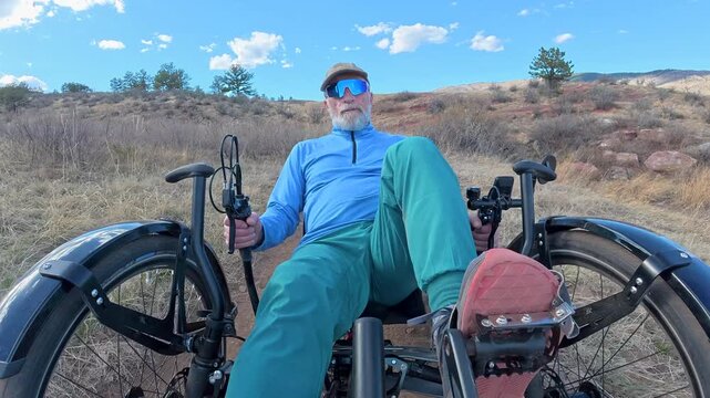 Senior cyclist is riding a full suspension recumbent on a rough mountain trail in northern Colorado foothills - Bobcat Ridge Natural Area