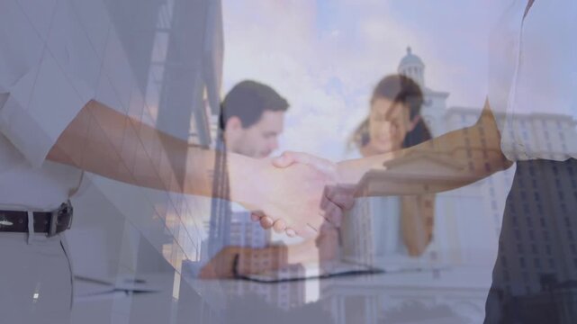 Composite video of mid section of businessman and businesswoman shaking hands against tall buildings
