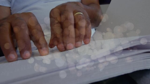 Animation of light spots over hands reading braille