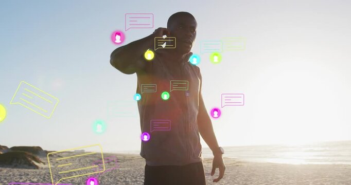 Animation of multiple icons, african american man adjusting headphones and looking at smartwatch