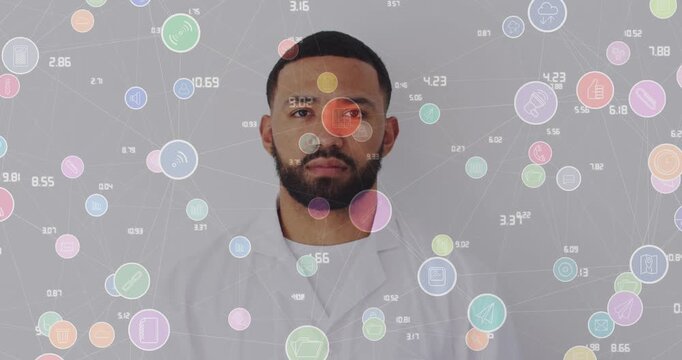 Animation of network of connections with icons over man smiling at camera