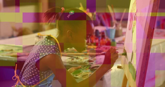 Girl reaching for brush, dipping into palette, painting fruit on easel refining details for art