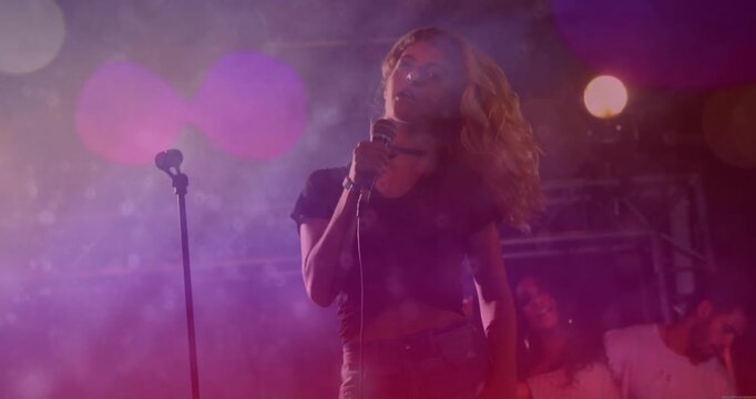 Lead singer on stage whipping hair sparking mic waveform settling to steady pose to emphasize music