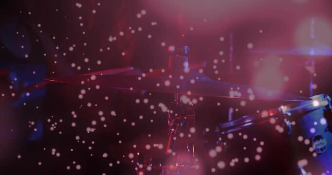 Lighting pulsing and particles drifting, drum kit becoming visible, cymbal edges glinting for music