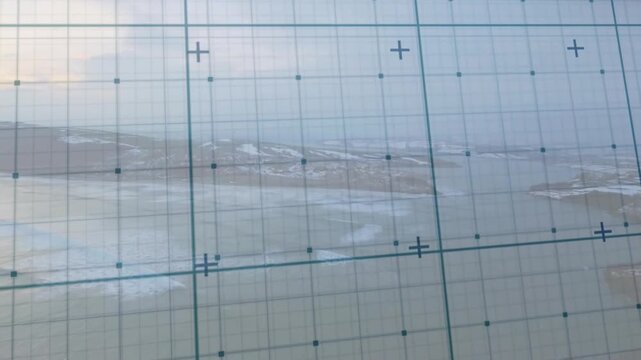 Camera panning and tilting causing teal grid film sliding over hazy coast stabilizing to align