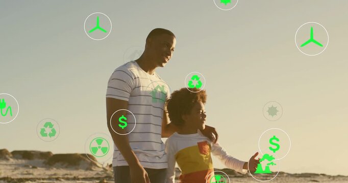 Father guiding child on beach, child pointing initiating floating green energy icons showing future