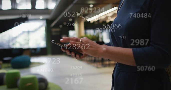 Mid adult woman standing in lounge tapping phone and making data overlay then settling for analysis