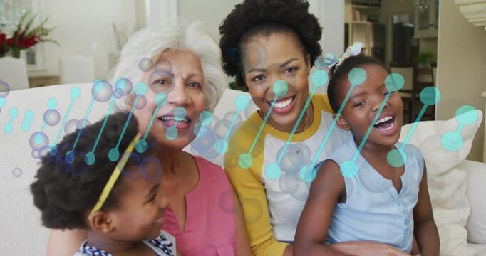 Leaning mother in yellow top eliciting right child laughing at home on sofa, teal overlay drifting