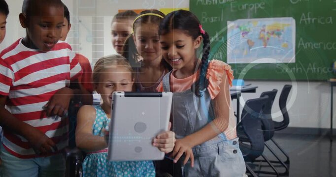 Girl in mobility chair turning tablet, classmates gathering and viewing screen for classroom lesson
