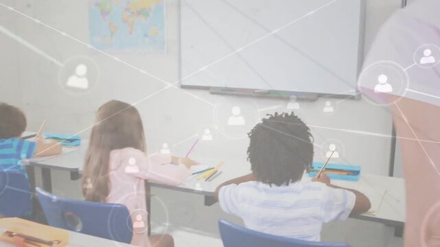 Teacher marking worksheet in class, activating marks on board, walking to front checking progress