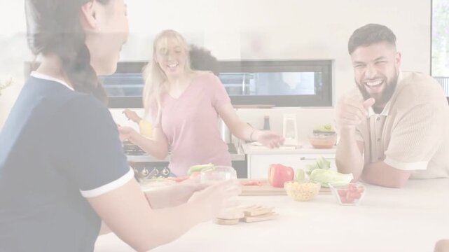 Vertical video: Braided navy woman passing glass, joining friends at island with pan, veggies