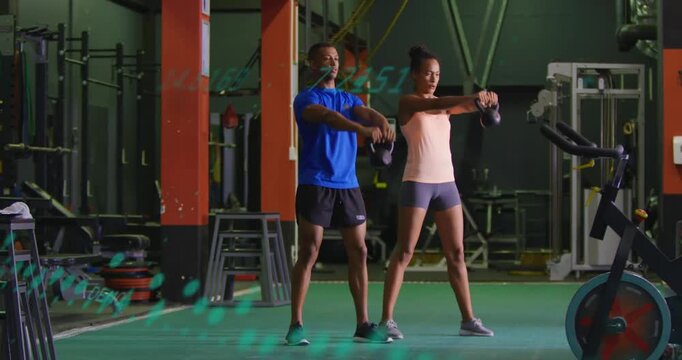 Male-female duo hinging hips swinging kettlebells for fitness as green dotted overlay crossing them
