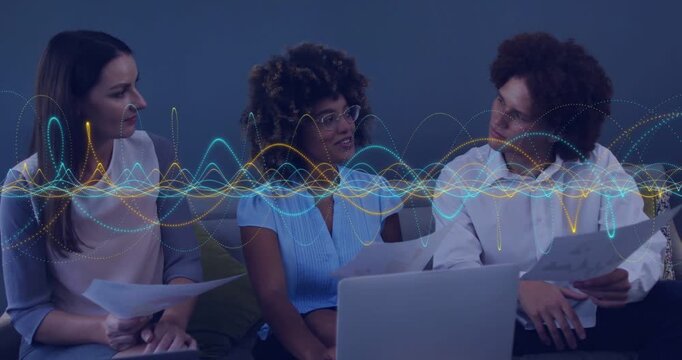 Team reviewing laptop, docs couch center glancing up, speaking, waveform showing talk for business