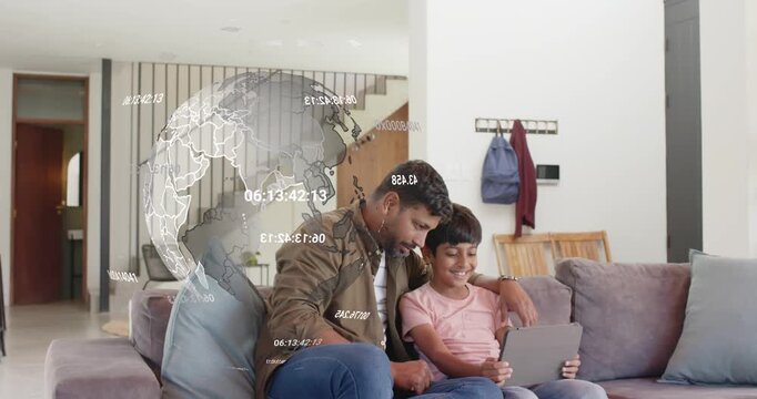 Father placing tablet on son's lap, guiding son tapping in home globe overlaying them teaching maps