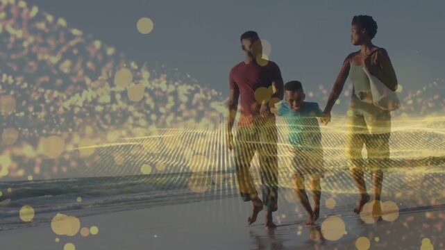 Family walking beach, child skipping, camera zooming causing gold bokeh band over family for travel