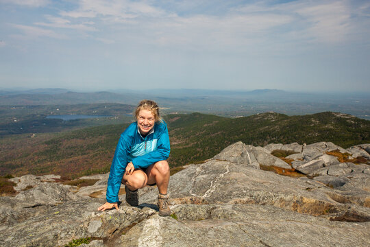 Young female hiker poses atop Mount Monadnock