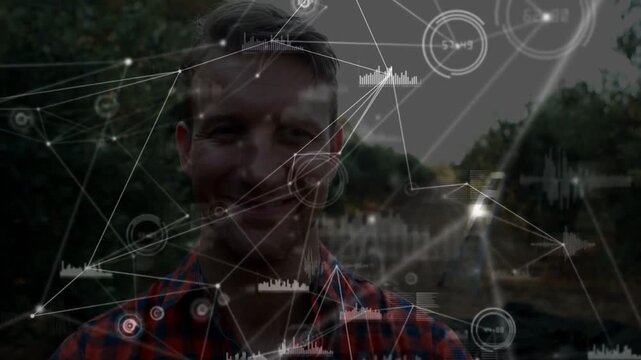 Man uncrossing arms and stepping forward, causing tech HUD nodes mapping yard features