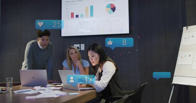 Seated woman typing and pointing laptop sparking animated likes rising as team viewing sales charts