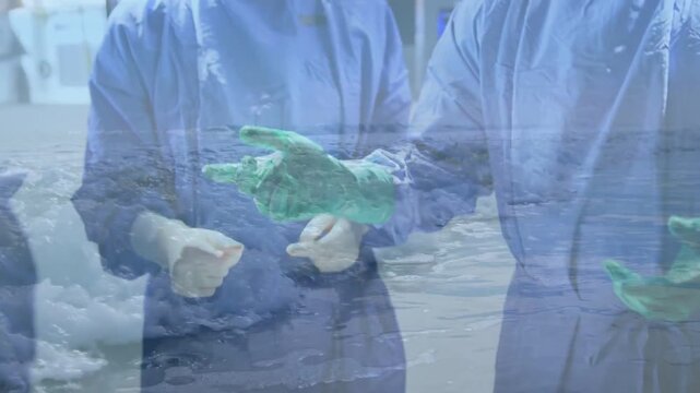 Surgeon reaching for green glove, team donning gloves, prepping tray for surgery with ocean overlay