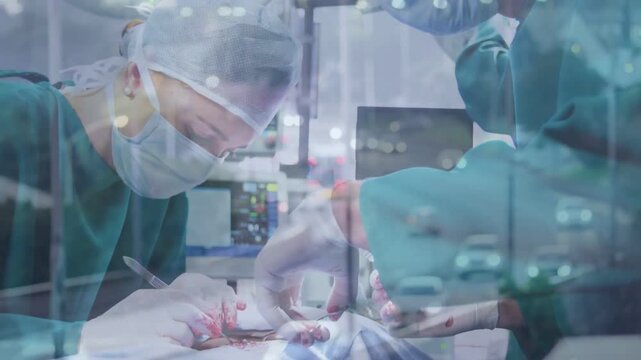 Male and female surgeons making incision and suturing to close wound while traffic overlay flows