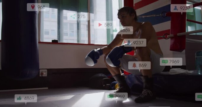 Resting adult boxer with blue gloves after round, watching alerts rising in ring corner, copy space