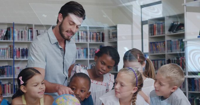 Vertical video: Leaning teacher in short shirt pointing at globe in library teaching kids maps
