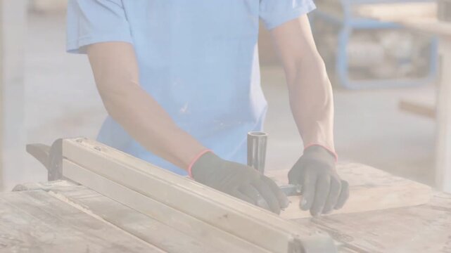 Vertical video: Placing board on guide, man light-blue-shirt marking at bench for cutting with tool