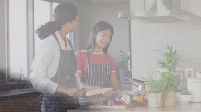 Vertical video: Mom starting cutting guiding teen chopping veg on board for meal, grain overlaying