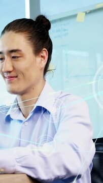 Vertical video: Camera revealing tech pro, HUD crossing man, typing on laptop, smiling for work