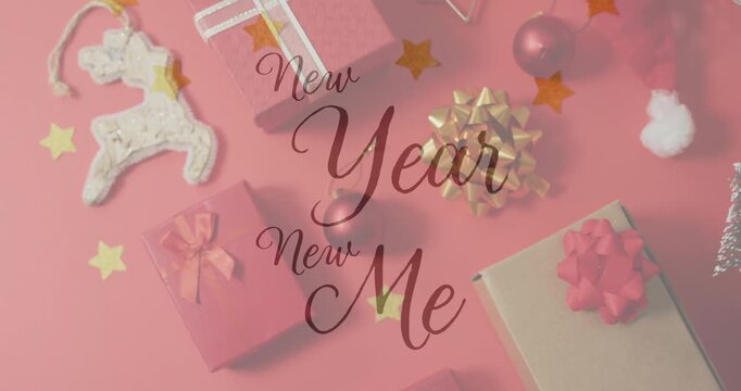 Animation of christmas greetings text over christmas presents and decorations