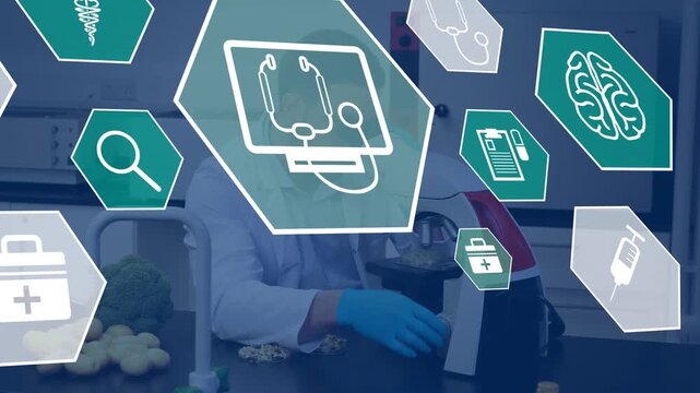 Animation of medical icons over caucasian male scientist using microscope in lab