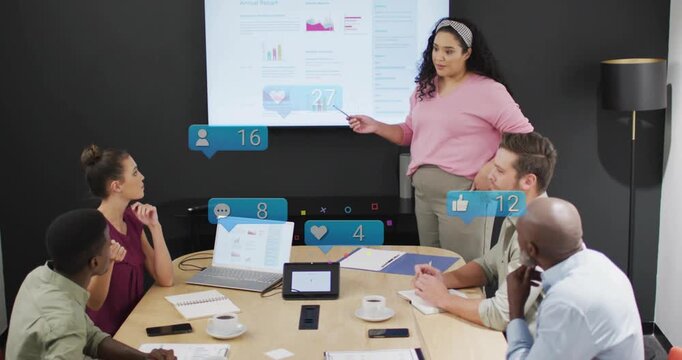 Presenter pointing at charts in business meeting, initiating reaction bubbles showing engagement