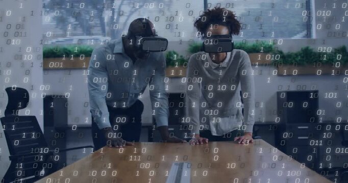 Team in VR headsets leaning on table, running tech sim for planning, gesturing at binary overlay