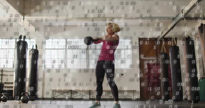 Vertical video: Woman lowering kettlebell above hinging and swinging for fitness binary overlaying