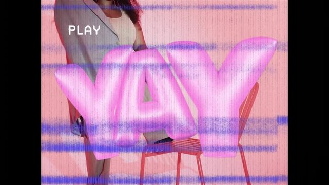 Vertical video: Fashion model stepping behind YAY, posing on chair draping blazer as PLAY appearing