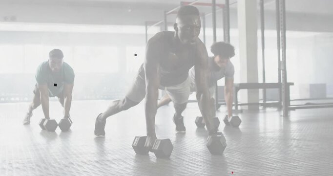 Center man leading renegade rows lifting dumbbell, two partners mirroring plank rows for fitness