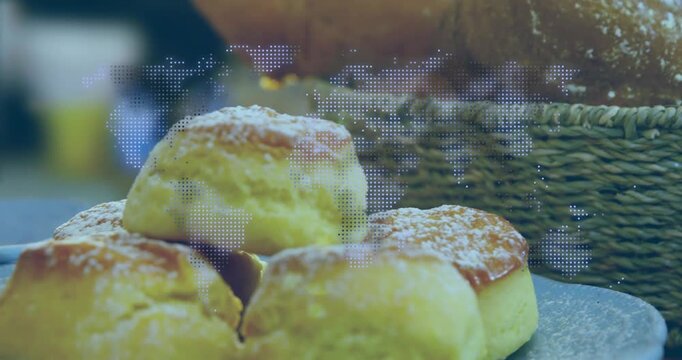 Camera tilting, pulling back, four rolls on plate coming into focus showcasing bakery dotted map