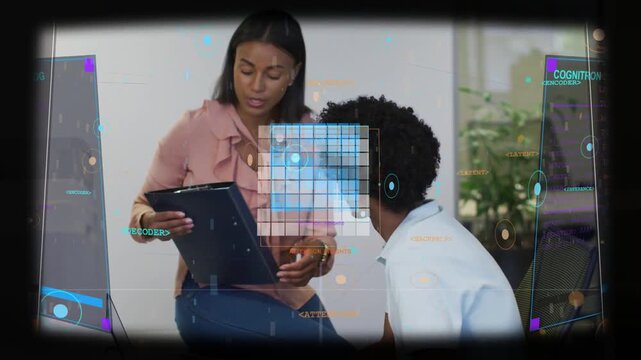 Woman in pink blouse holding tablet, training man in white polo at office desk, HUD overlay