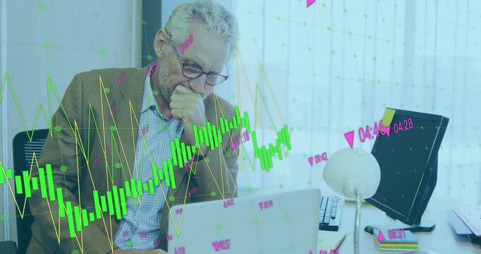 Vertical video: Senior exec leaning typing on laptop updating charts and pink markers for finance