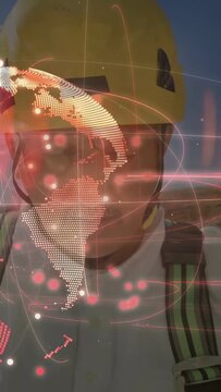 Vertical video: Worker in hard hat tapping phone, AR globe rotating in front showing site map
