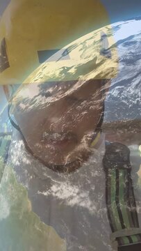 Vertical video: Site worker tilting head, rotating globe overlay fading, revealing helmet and face