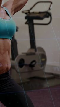 Vertical video: Woman bracing stance and pressing dumbbell in gym, overlay numbers tracking reps