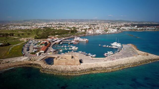Beautiful aerial footage showing the historic paphos castle, marina, and city skyline in cyprus