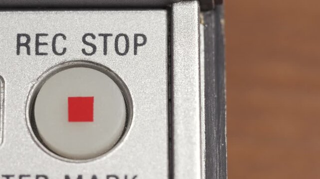 Close up of Rec Stop button with red square on silver panel and copy space