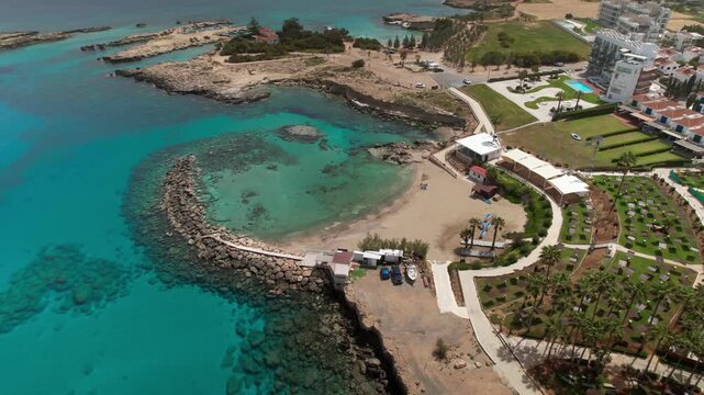 Beautiful aerial descending shot of sirena bay with turquoise water and sandy beach in cyprus