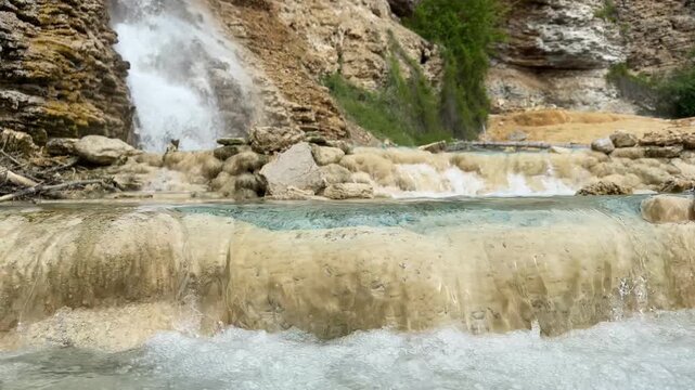 Fairmont Hot Springs waterfall cascades over travertine rock formations and mineral pools