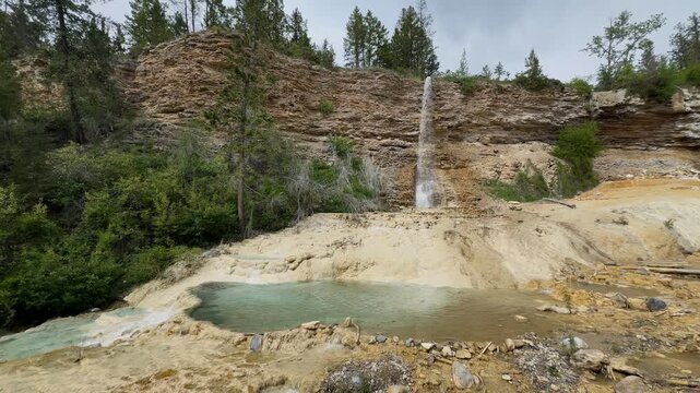 Fairmont Hot Springs waterfall cascades over travertine rock formations and mineral pools